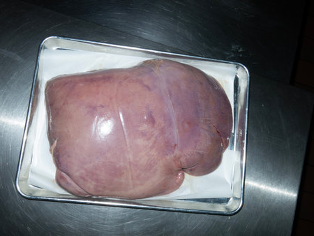 Raw meat on a stainless steel cutting board. Top view.の写真素材