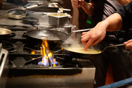 Chef cooking thai style food in the kitchen at restaurant.