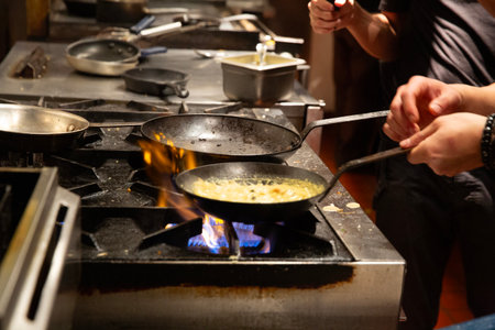 pot with omelette on the fire in the kitchen of a restaurantの写真素材