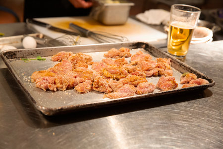 Fried pork cutlets on a baking sheet with a glass of beerの写真素材