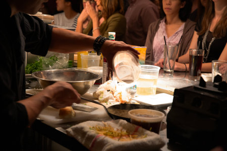 Crowd of people waiting for food in a restaurant to be servedの写真素材