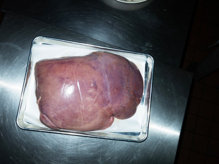 Raw chicken heart on a cutting board. Raw chicken heart on a cutting board.の写真素材