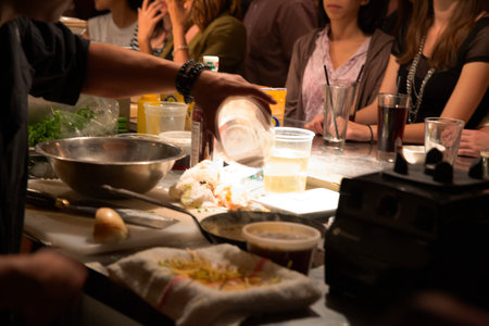 Hands of a chef preparing a meal in a restaurant, close up