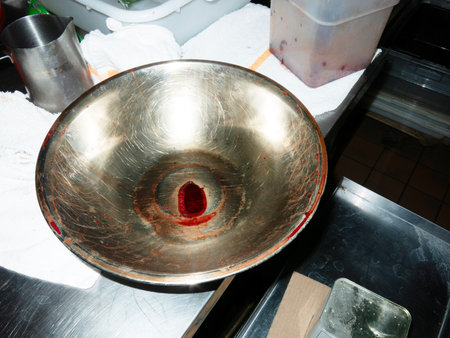 Stainless steel bowl on the counter in a restaurant, closeup of photoの写真素材