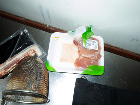 Slices of pork in plastic bag on table, stock photoの写真素材