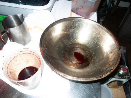 Stainless steel pan with liquid on the kitchen table.の写真素材