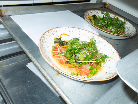 Salmon salad with arugula and olive oil in a restaurantの写真素材