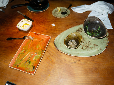 Ceramic plates and cutlery on a wooden table.の写真素材