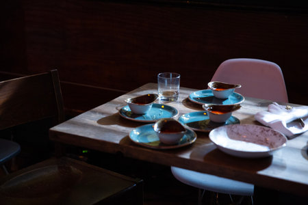 Colorful ceramic tableware on a wooden table in a restaurant.の写真素材