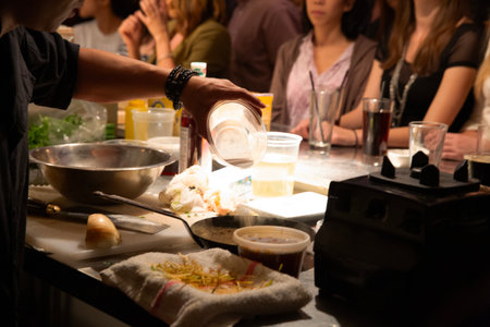 Close-up shot of a chef preparing a meal in a restaurantの写真素材