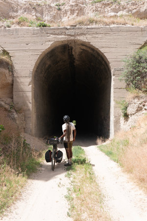 A man with a bike in the middle of a tunnel in Cyprusの写真素材
