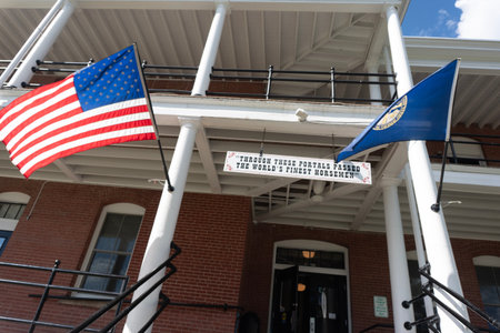 The American flag and another flag in front of a building.の写真素材