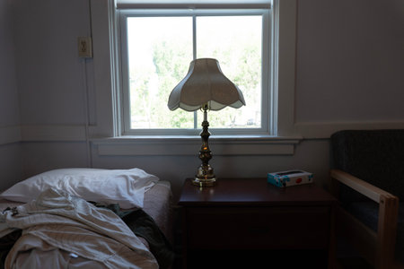 Lamp on the bedside table in the interior of the room