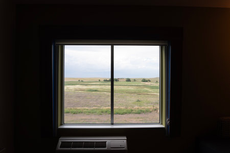 Window view of the field. Countryside landscape in the background.の写真素材