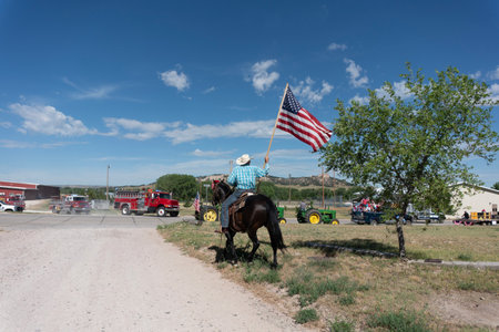 Horseman riding on the road with the american flag.の写真素材