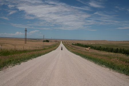 A rural road in the middle of the steppe and a blue skyの写真素材
