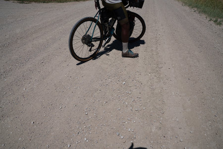 Cyclist riding a mountain bike on gravel road in the countrysideの写真素材
