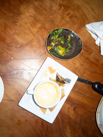 Mushroom soup with spinach on a wooden table in a restaurantの写真素材