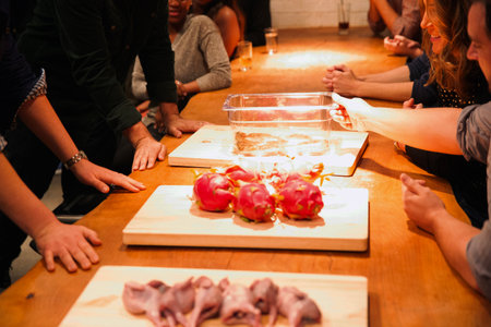 Group of people eating and drinking in a bar at a party.の写真素材