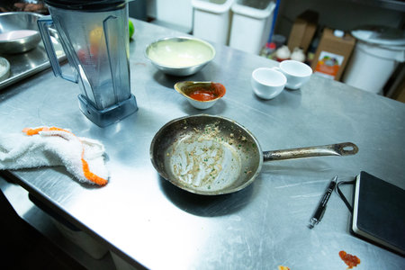 Frying pan in the kitchen of a restaurant. Preparing food.の写真素材