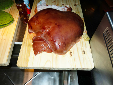 Raw pork knuckle on a chopping board in a butcher shop.の写真素材