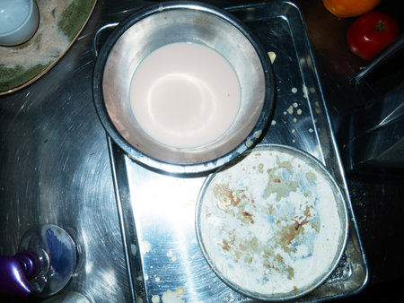 The process of cooking pancakes on a gas stove in the kitchen.の写真素材