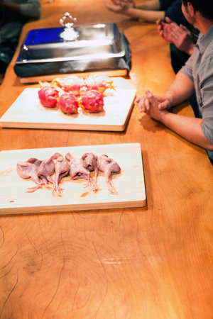Chicken meat on wooden cutting board in restaurant, ready for cookingの写真素材