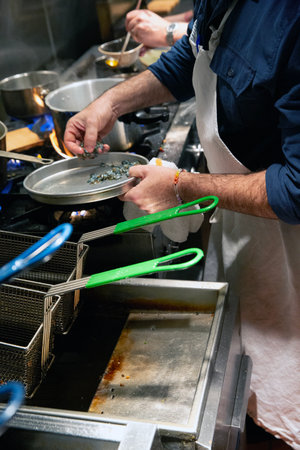 Chef at work in a restaurant kitchen. Chef cooking in a restaurant kitchenの写真素材
