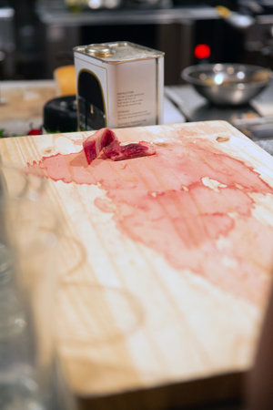 Cutting meat on a cutting board in a restaurant kitchen. Selective focus.の写真素材