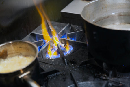 Cooking on the gas burner in the kitchen of a restaurant.の写真素材
