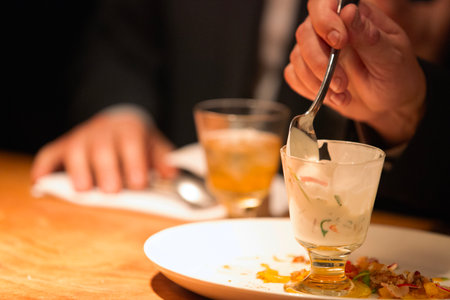Chef in a restaurant serving a plate of appetizer with ice creamの写真素材