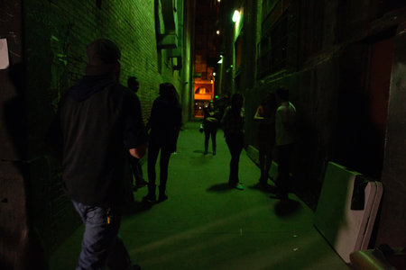People walking in the street at night in London, England, UKの写真素材