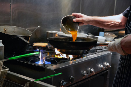 Chef preparing food in the kitchen of a restaurant or hotel.の写真素材