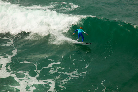 surfer in action on the ocean wave on a sunny day.