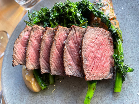 Grilled beef steak with kale and parmesan on a plate