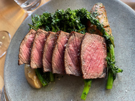 Beef sirloin with kale and mushrooms on a plate.の写真素材