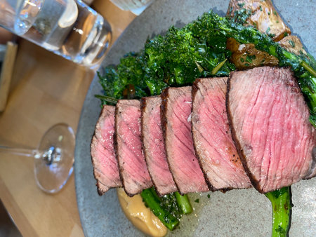 Grilled beef steak with kale and asparagus in a restaurantの写真素材