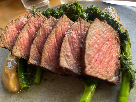 Roast beef with kale and asparagus on a plate.の写真素材