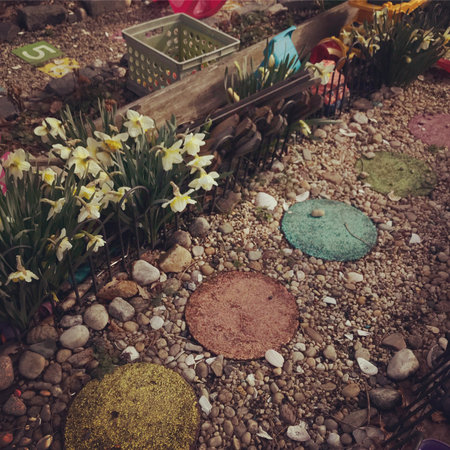 Garden decoration with spring flowers. Vintage style toned picture.の写真素材