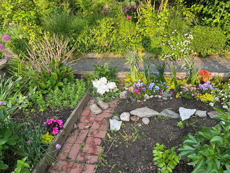 Garden design with flowerbeds and pebbles in summerの写真素材