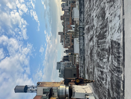 Houses on a background of blue sky with white clouds in New York Cityの写真素材