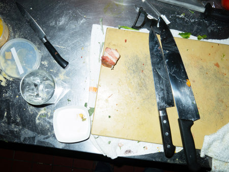 Cooking meat on the kitchen table with a knife and a forkの写真素材