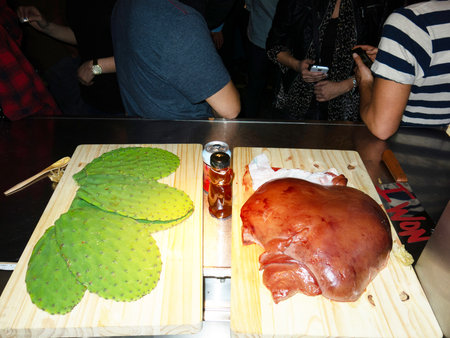 Prickly pears and smoked meat on a wooden board.の写真素材