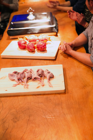 Raw chicken meat on cutting board in a japanese restaurant.の写真素材