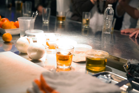 Close-up of bar counter with ice cubes and glasses of whiskey