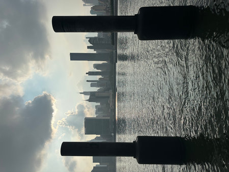 Reflection of skyscrapers in the water with a lens flareの写真素材