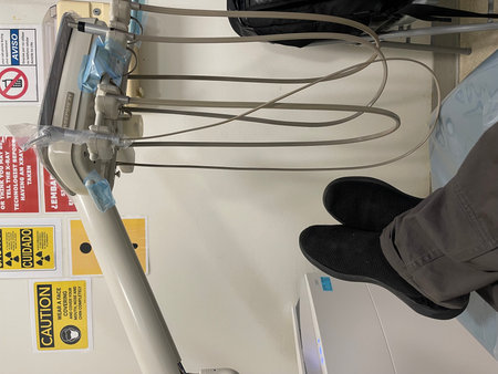 Hospital room with a drip bag attached to a bedside tableの写真素材