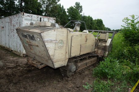 Old bulldozer in the field. Dump truck on the ground.の写真素材