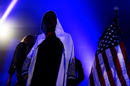 Concert crowd in front of a stage with lights and spotlightsの写真素材