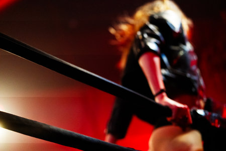 Crowd at boxing match in front of bright stage lights during live eventの写真素材